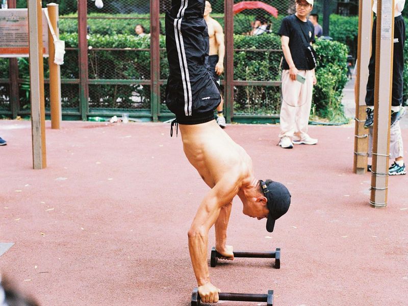 Man moving through a sequence of bodyweight exercises.