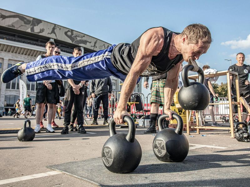Man performing a kettlebell exercise with perfect form.